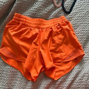 Bright orange lululemon hotty hot shorts